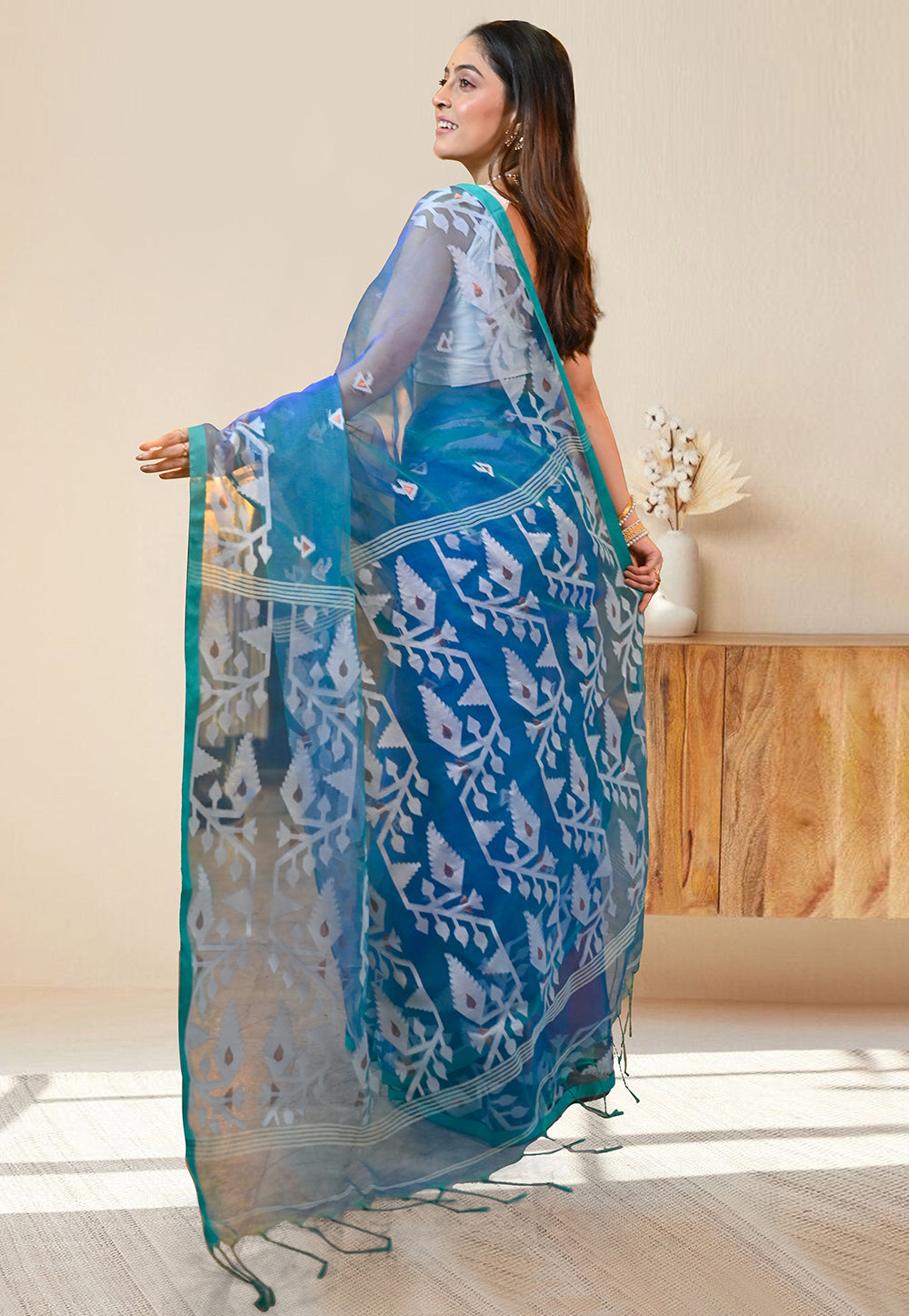 PURE HANDWOVEN MUSLIN SILK SAREE IN TEAL BLUE COLOR WITH OFFWHITE FLORAL MOTIFS AND GREEN BORDER