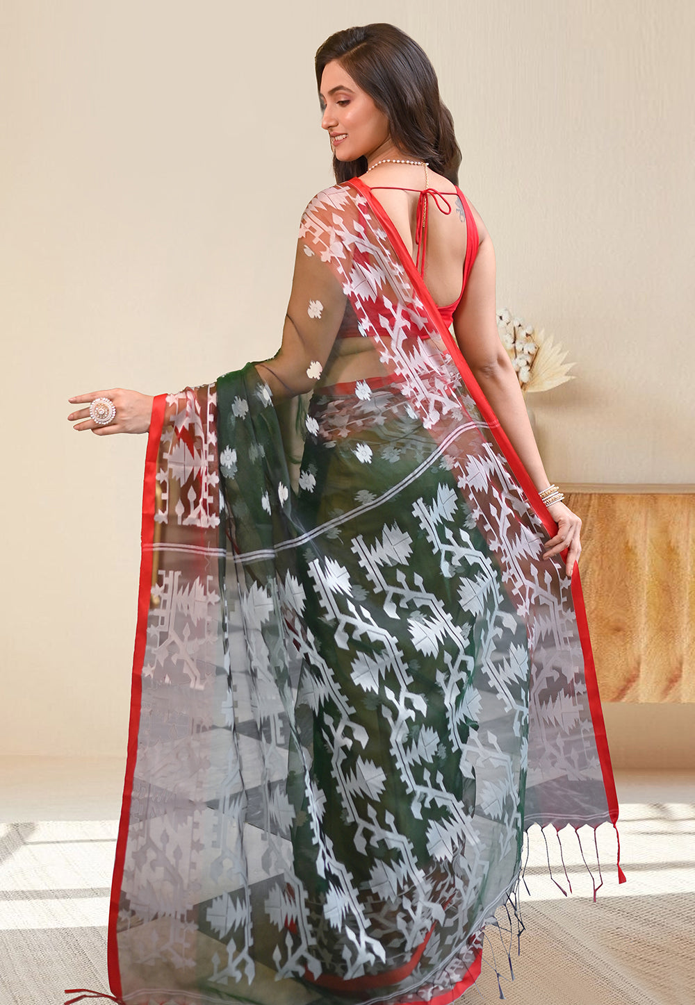 PURE HANDWOVEN MUSLIN SILK SAREE IN FOREST GREEN COLOR WITH OFFWHITE FLORAL MOTIFS AND RED BORDER