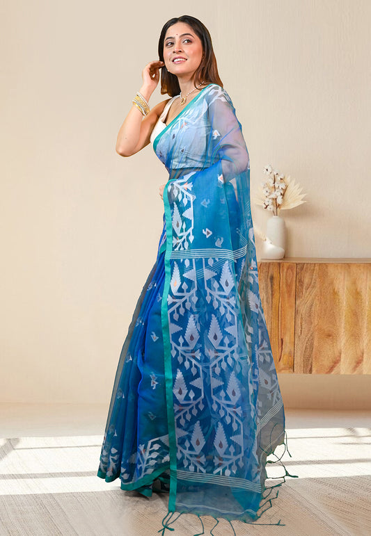 PURE HANDWOVEN MUSLIN SILK SAREE IN TEAL BLUE COLOR WITH OFFWHITE FLORAL MOTIFS AND GREEN BORDER